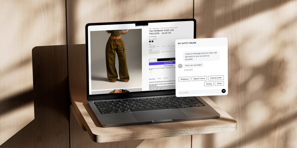 Laptop displaying an e-commerce page for wide-leg olive pants with a live chat support window open on the right.