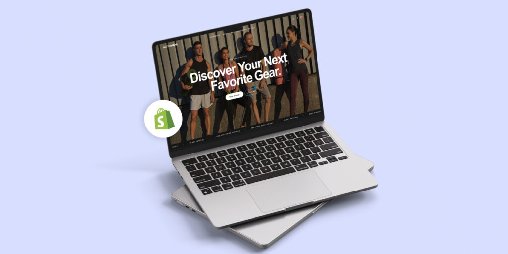 Laptop mockup showing a modern activewear Shopify homepage with the headline “Discover Your Next Favorite Gear,” featuring a group of athletes and a floating Shopify logo to represent building a clean, professional ecommerce website.